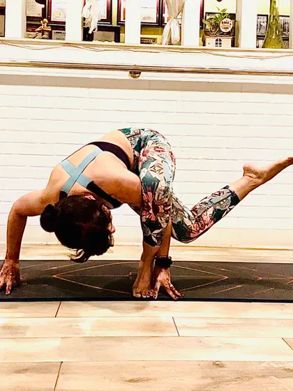 A challenging balancing twist that requires core strength and flexibility. This pose is a reminder that your body is your most priceless possession, and it's important to prioritize your health, especially during festive seasons.