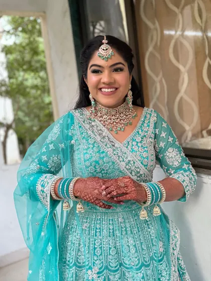 A dreamy, ethereal look for a Sangeet or reception. The soft shimmer on the eyes and subtle lip colour complement her stunning turquoise lehenga.