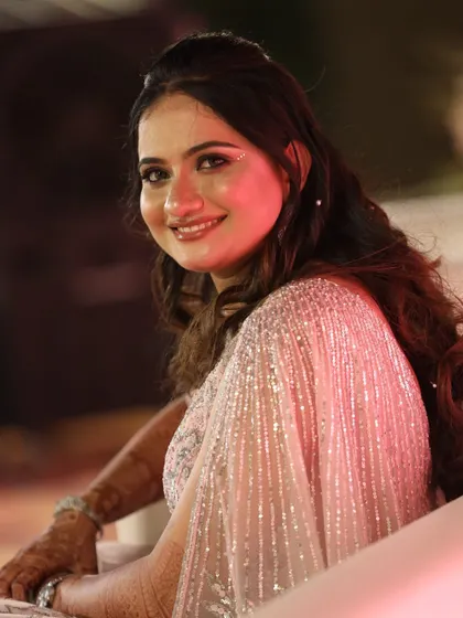 Another angle of this beautiful reception makeup, showing how the light catches the subtle shimmer on her skin.