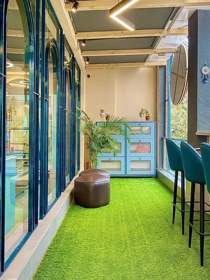 Our balcony space is the perfect spot to catch your breath before or after class. The vibrant green turf and comfortable seating create a refreshing little oasis.