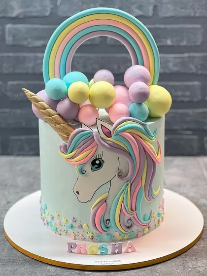 This unicorn cake is so vibrant and cheerful! The hand painted unicorn, rainbow, and colorful balloon details make it a joyful centerpiece for any kid's party.