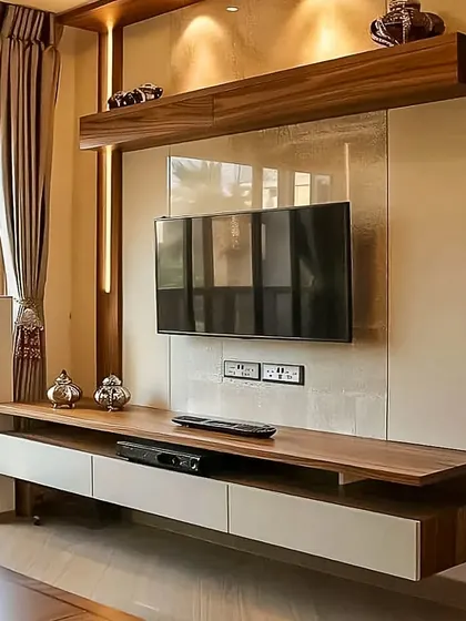 This design features a floating wooden console with white drawers, providing a clean look with practical storage for media devices.