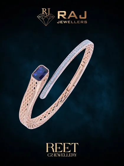 This modern rose gold kada showcases a sleek, open design, culminating in a striking blue gemstone set against a backdrop of sparkling CZ stones. Its architectural form and detailed meshwork offer a perfect blend of contemporary style and classic elegance.