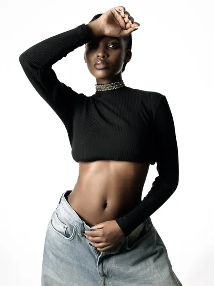 A beautiful and confident pose against a clean white backdrop. The lighting is flattering and highlights the model's features perfectly.
