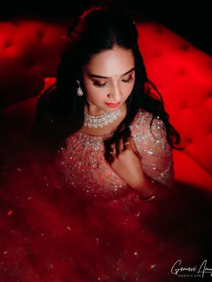 Aishwarya in a stunning, embellished pink lehenga for her reception. I created a glamorous look with shimmery eyes and a bold lip, captured here under dramatic red lighting.