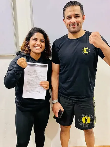 Priya Sharma with her coach, a critical part of her success. A fighter's journey is a team effort.