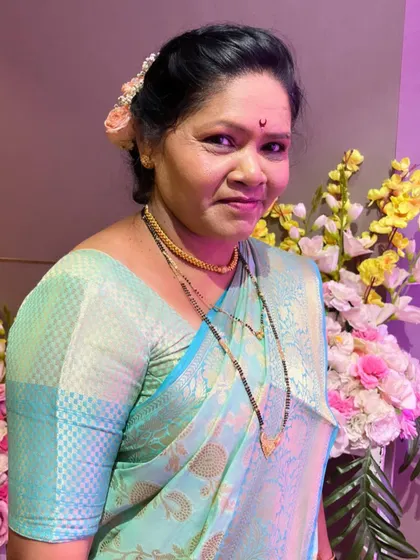 A close-up of the bride's mother, her makeup looking fresh and natural.