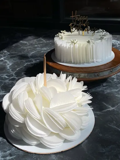 Two of my favorite white cakes together! The textured wafer paper bloom and the pleated wafer paper design look so elegant side-by-side.