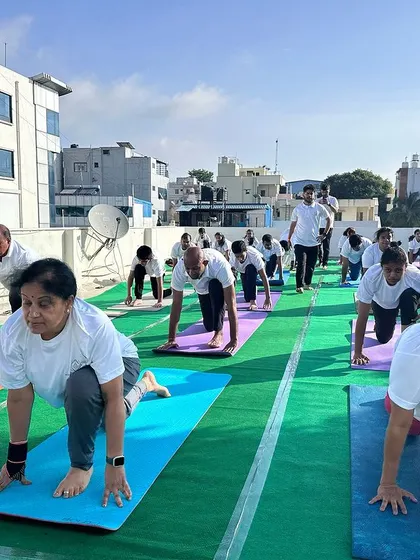 Students in Ashwa Sanchalanasana (Equestrian Pose) during a group practice. The focus and dedication of each participant are clearly visible.