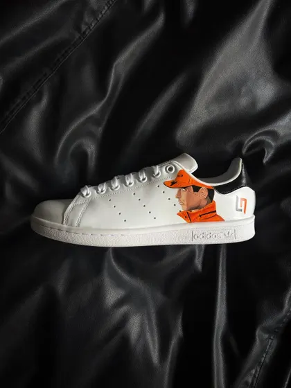 A side profile of the other shoe, featuring a detailed portrait of Lando Norris in his McLaren gear.