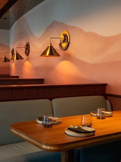 A row of our comfortable booths, each lit by its own brass sconce. This is where you can settle in for the evening and enjoy the food and company.