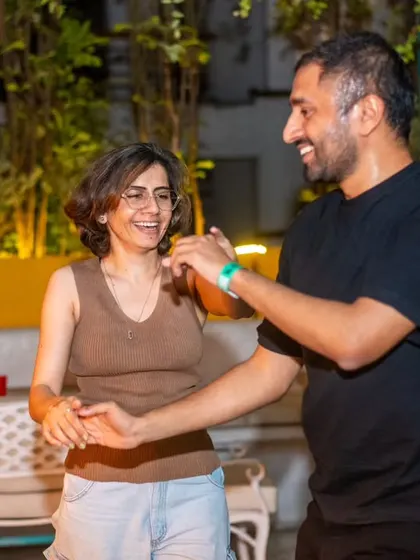 A relaxed and happy couple enjoying a dance. The atmosphere is perfect for unwinding and having a good time.