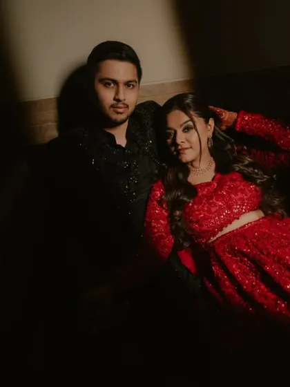 A dramatic, moody portrait of the couple from their reception, using shadows and light for an artistic effect.