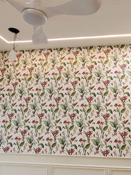 A full wall covered in a repeating botanical pattern with red flowers and green leaves. This classic design brings life and color to the bedroom.
