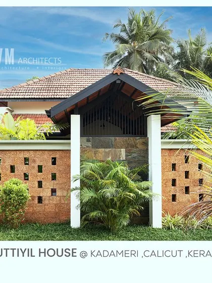 The exterior wall of Kuttiyil House is built with natural red laterite stone, a classic material in Kerala architecture that adds warmth, texture, and a timeless charm.