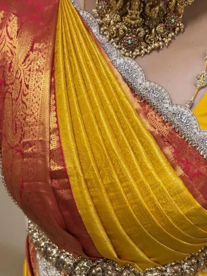 A detailed shot of the right-side pallu, showing the crisp pleats and how they are secured. This style offers a unique and modern twist to traditional saree draping.