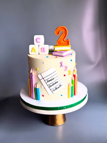 A cake for a preschooler's 2nd birthday, because you can have your 'Padhai' and eat it too! This design features edible ABC blocks, books, and colored pencils.