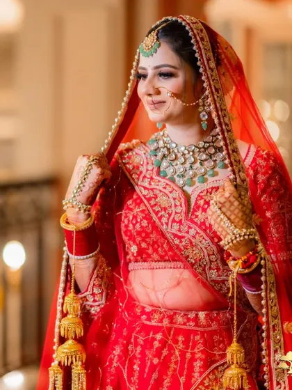 The bride adjusting her veil, a classic and graceful pose for a bridal portrait.