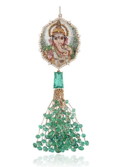 This Lord Ganesha pendant is a piece I hold very dear. The micromosaic portrait is set in 18k gold with a tassel of Zambian emeralds from Gemfields. On the back, I have etched the Vakratunda Mahakaya shloka to banish obstacles and welcome new beginnings.