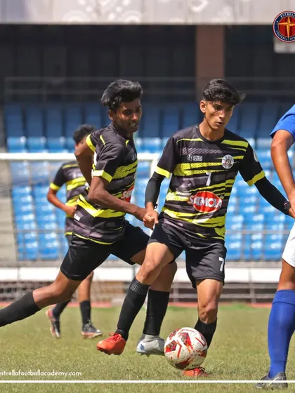 Two of our players in a tense moment during a B Division match. The high stakes of league football push our players to perform at their best.