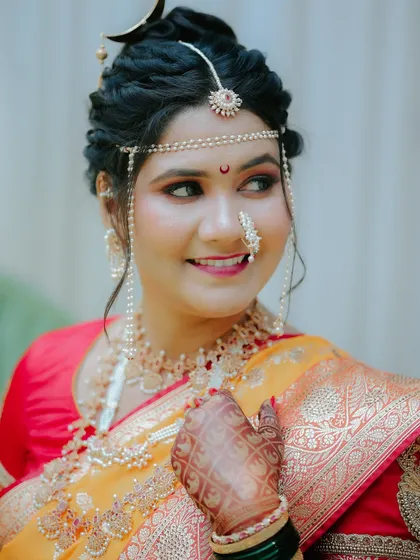 A detailed close-up of the Maharashtrian bride, focusing on her traditional jewelry, like the nath and mundavalya.