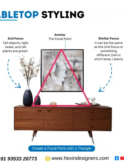 For tabletop styling, we create a focal point using a triangular composition. An anchor piece, like artwork, is balanced by items of different heights on either side, such as a tall vase and a lamp.