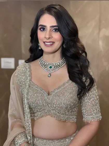 Embracing the elegance of subtle glam for this perfect engagement bride. The soft curls and natural-looking makeup enhance her features beautifully, creating a timeless and sophisticated look.
