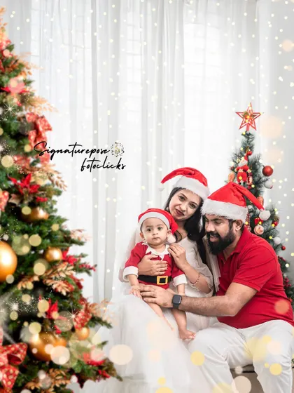 A close-up of the family during their Christmas mini-session. This shot captures the warmth and love between the parents and their little one, with the twinkling lights of the tree creating a magical bokeh effect.