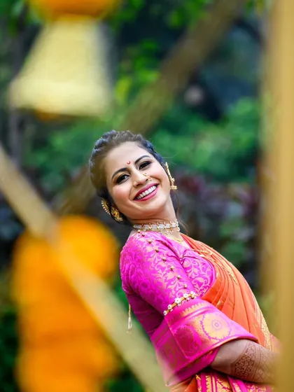 A fun and dynamic shot of Shamika. I captured this through the marigold decorations, which adds a layer of color and context to her bridal portrait.