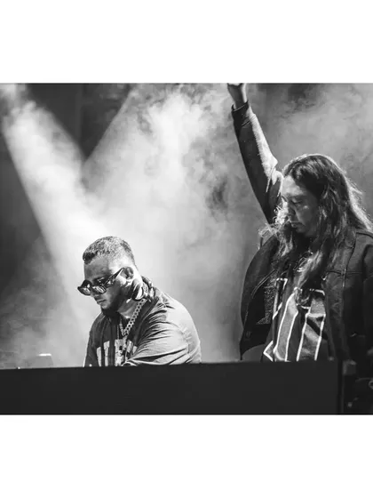 A black and white shot of me and DJ Andre on stage at the Artist Connect Dance Music Festival.