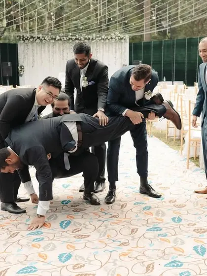 The groomsmen having some fun before the Catholic wedding ceremony. We love capturing the energy of the bridal party.