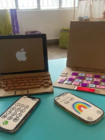 Our Playmakers are also toymakers. Here are some incredible cardboard laptops and phones they created for the children's pretend play, showing that the best toys are often handmade with love.