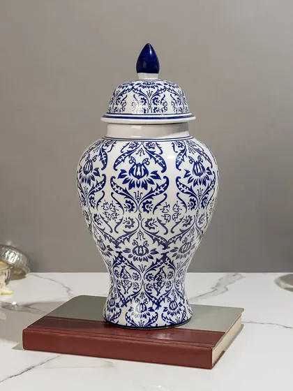 This classic ginger jar shape is a staple in my blue pottery collection. The intricate damask-style pattern makes it a sophisticated decorative vase for any room, perfect for adding a touch of timeless elegance.
