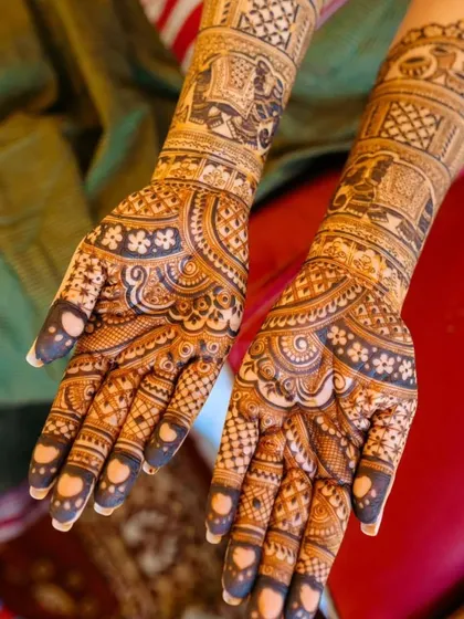 A beautiful shot of a bride's full mehndi. The design incorporates traditional elephant and palace motifs, creating a classic and timeless bridal look.