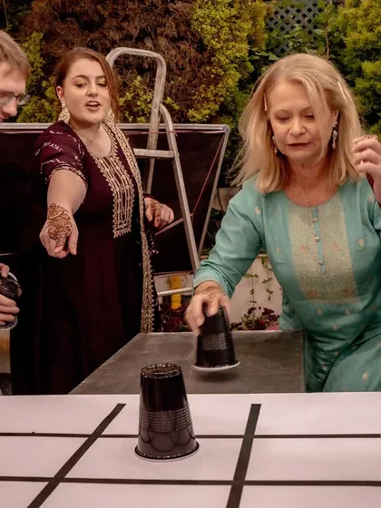 Guests enjoying a game of tic-tac-toe with cups during the Mehendi, a simple yet highly entertaining activity for all ages.