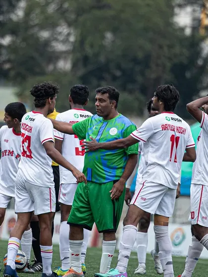 A moment of discussion and tactical adjustment on the field during a game.