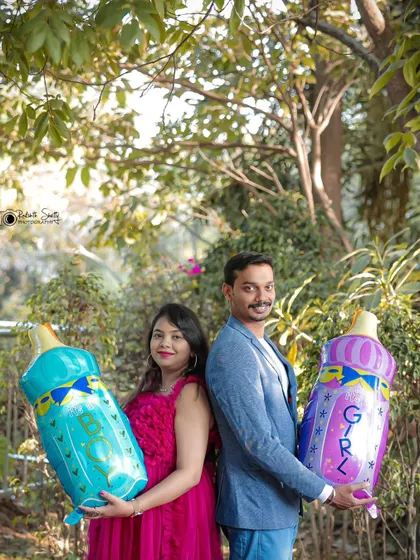 Boy or Girl? This fun photo with "Boy" and "Girl" baby bottle balloons is a perfect idea for a gender reveal photoshoot or a playful baby shower picture.