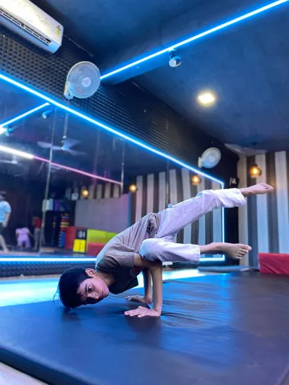 Strength and control are fundamental to our training. This student demonstrates an advanced hand balance, a skill developed through our specialized gymnastics for dancers program.