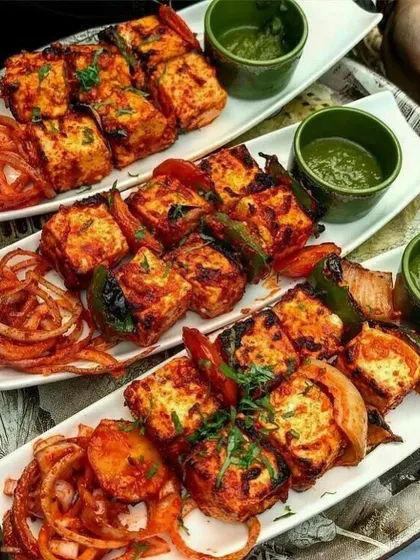 A beautiful platter of freshly grilled Paneer Tikka, served with zesty green chutney and pickled onions. This is a crowd favourite at weddings and parties.