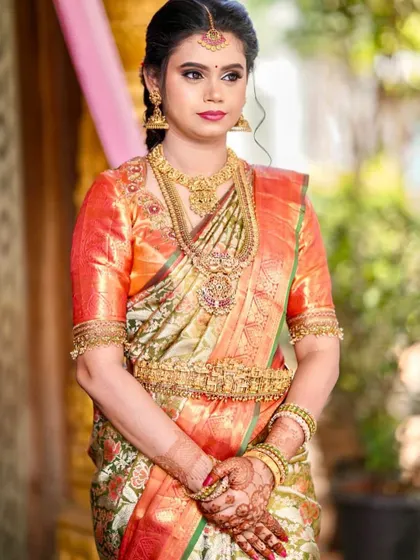 A client looking beautiful in a classic Meenakari designer silk saree, known for its colorful enamel work.
