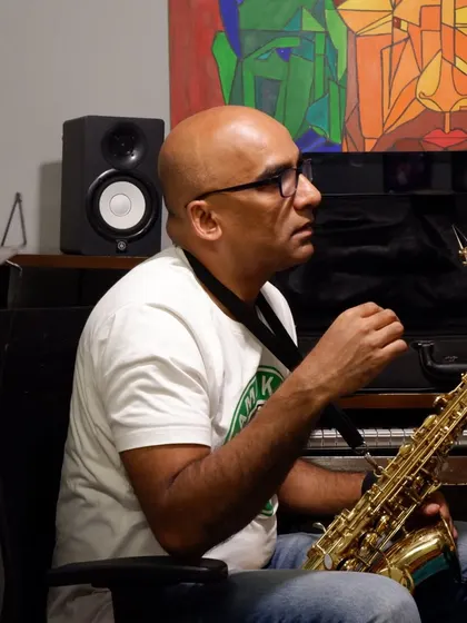 A student practicing saxophone in our studio. The space is designed to be comfortable and inspiring for solo practice sessions.