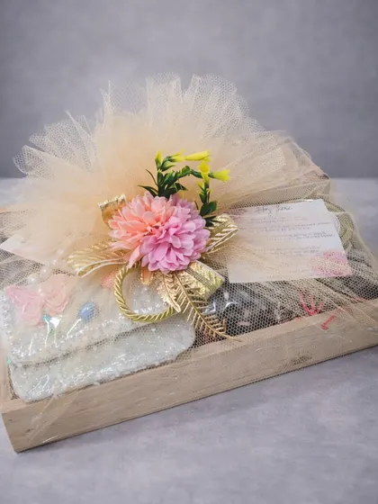 A baby girl's birthday calls for a gift that is as beautiful as it is thoughtful. This curated birthday hamper in a wooden tray includes an aroma diffuser, assorted chocolate truffles, cookies, and cute accessories. The soft colors and premium treats make it a perfect gift for new parents and baby showers.