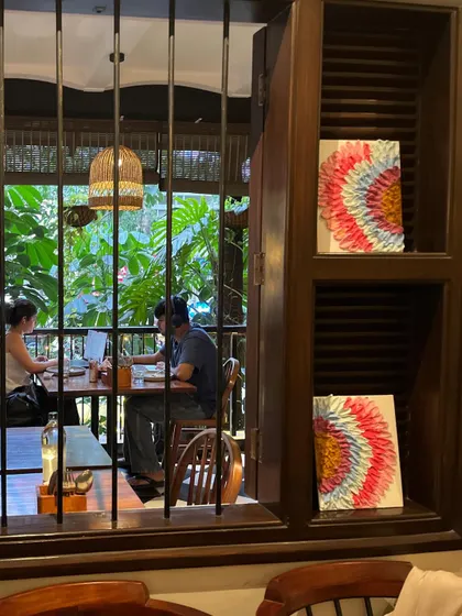 The finished couple's art pieces, seen from outside the cafe window. They add a touch of beauty to the space.