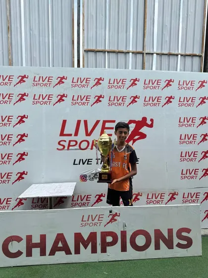 A proud player from our U13 team with the championship trophy.