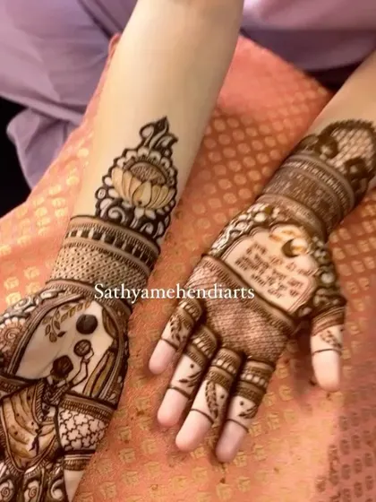 A detailed view of a Karwa Chauth mehendi. One hand shows the traditional sieve motif, while the other has a beautiful personalized message for the couple.