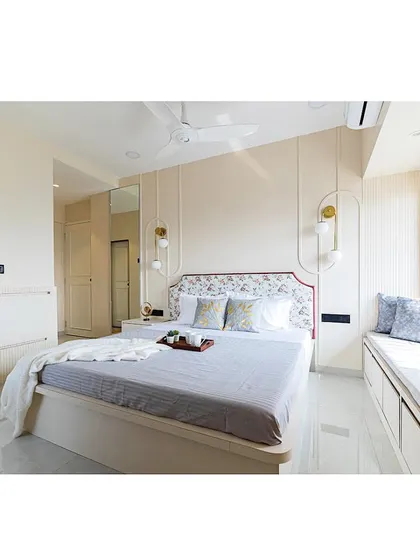 A serene and minimal bedroom design for a grandmother's room. The color palette is soft and neutral, with a floral headboard adding a touch of traditional charm.