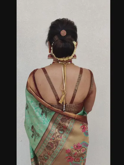 A textured low bun with a small gajra and a central hair accessory, showing how even simple updos can be elevated.