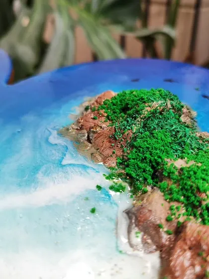 A detailed shot of the heart-shaped resin art, showing the texture of the mossy green cliffs.