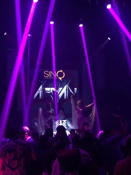 My name in lights at Sinq Nightclub, with dancers on stage. This shows the full entertainment package I bring, complete with visuals and performers.
