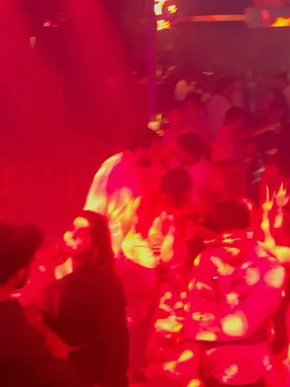 Another shot of the packed, red-lit dance floor at Happy Brew.